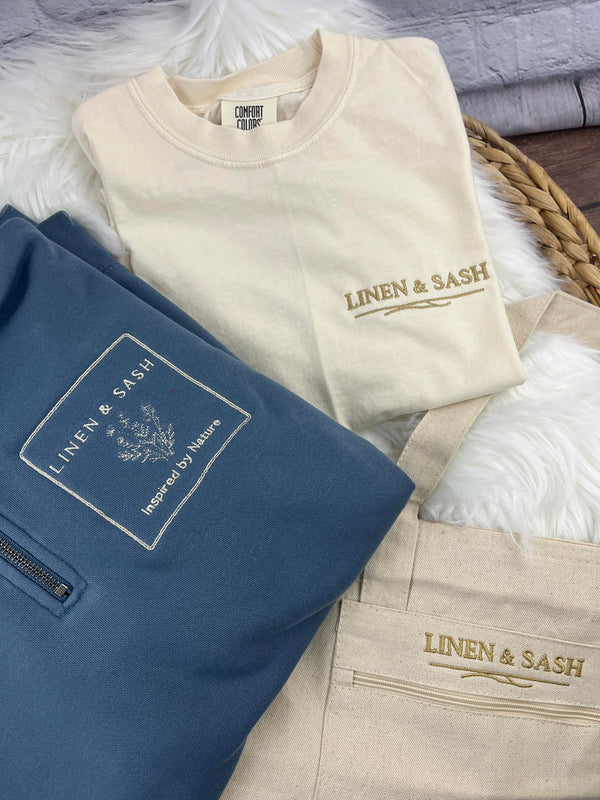 The Linen & Sash Lifestyle Set
Quarter Zip • Embroidered Tee • Canvas Tote
$99 (Save $18)
